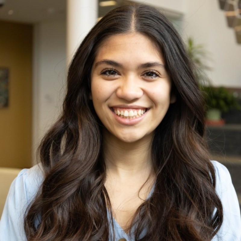 woman with brown hair smiling outside