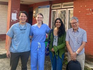 Group of people in front of a clinic building